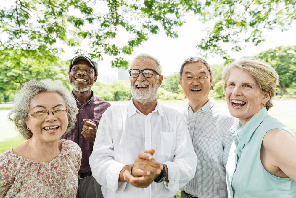 Seniors under a tree happy with their Medicare choices
